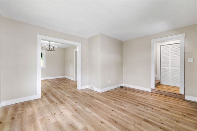 404 Ariston Ave, Carrick, PA 15210 - empty room with a chandelier, light wood-style flooring, and stairway