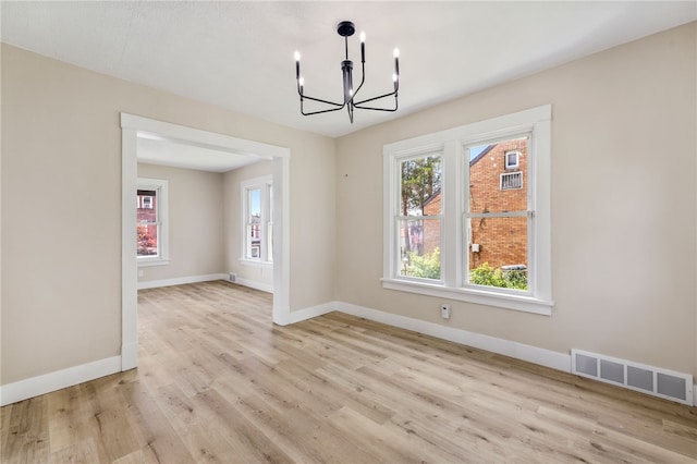 404 Ariston Ave, Carrick, PA 15210 - unfurnished dining area with a chandelier and light wood-type flooring