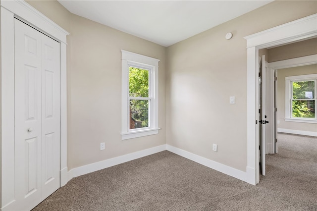 404 Ariston Ave, Carrick, PA 15210 - unfurnished bedroom with carpet floors, multiple windows, and a closet