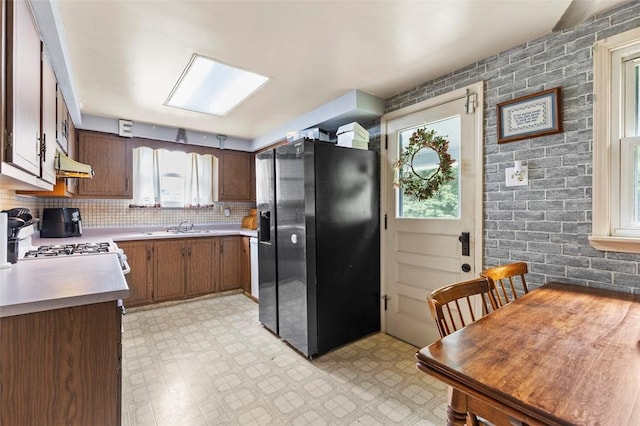 623 Rte 30, Findlay Twp, PA 15126 - kitchen featuring stainless steel refrigerator with ice dispenser, under cabinet range hood, light floors, and light countertops