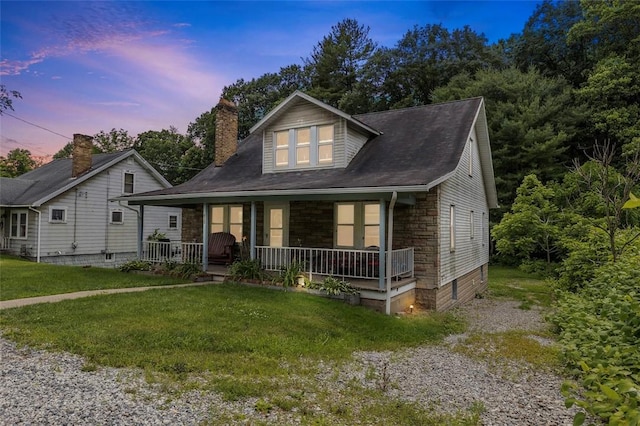 623 Rte 30, Findlay Twp, PA 15126 - bungalow-style home with a porch, a front lawn, stone siding, and a chimney