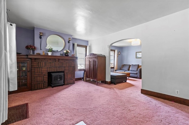 623 Rte 30, Findlay Twp, PA 15126 - carpeted living area featuring arched walkways and a wood stove