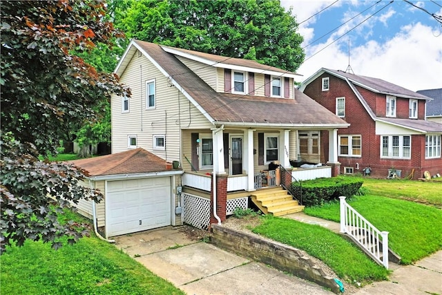 1107 W Ridge Ave, Sharpsville, PA 16150 - view of front of home featuring a porch, a front yard, concrete driveway, a garage, and roof with shingles