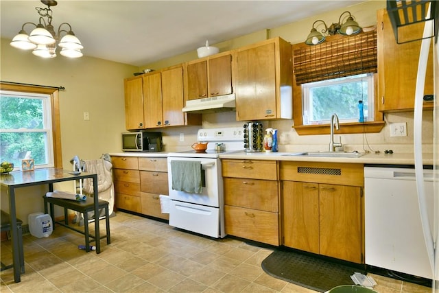 1107 W Ridge Ave, Sharpsville, PA 16150 - kitchen with white appliances, under cabinet range hood, healthy amount of natural light, and light countertops