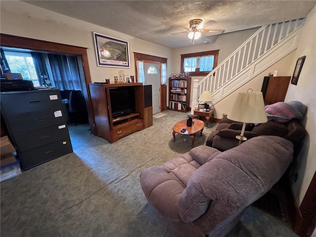 1506 Victoria Ave, New Kensington, PA 15068 - carpeted living room featuring stairs, a textured ceiling, and ceiling fan