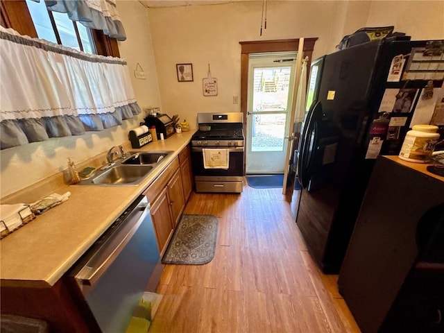 1506 Victoria Ave, New Kensington, PA 15068 - kitchen featuring stainless steel appliances, light wood finished floors, light countertops, and brown cabinets