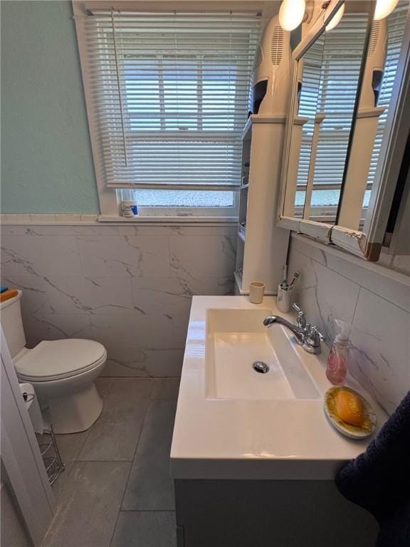 1506 Victoria Ave, New Kensington, PA 15068 - bathroom featuring tile walls, vanity, tile patterned floors, and wainscoting