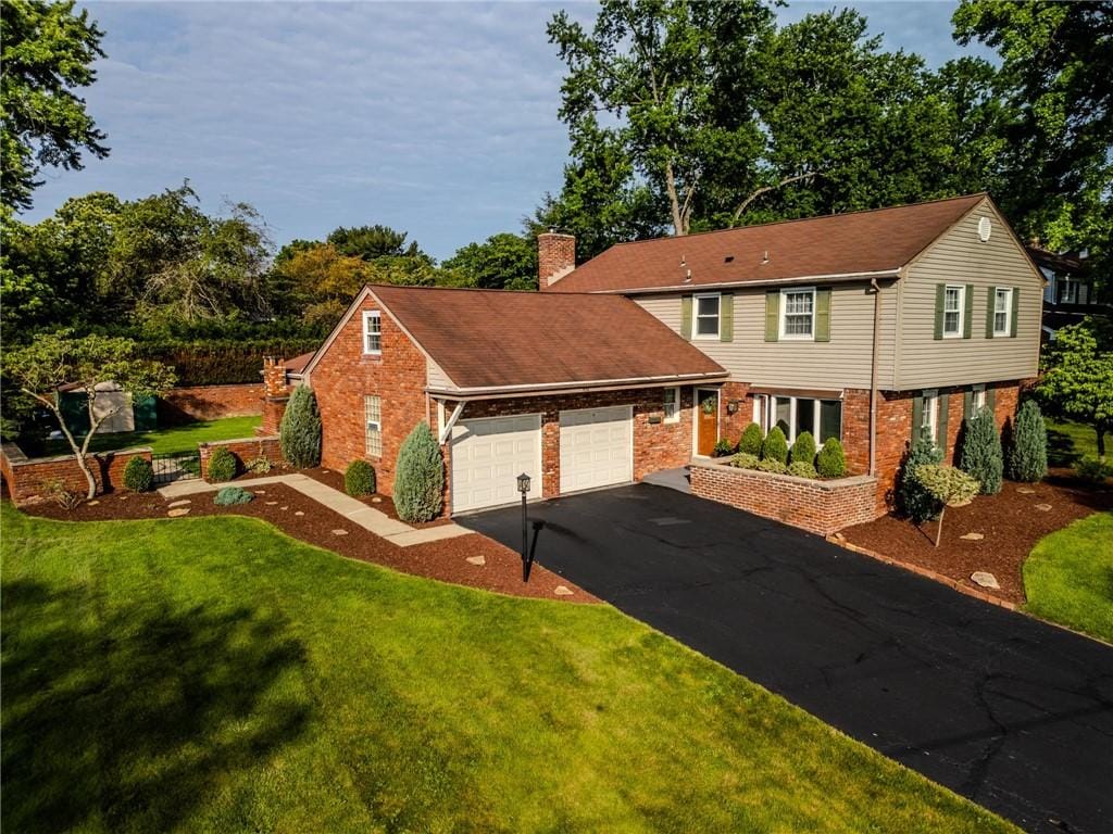 836 Fredericka Dr, Bethel Park, PA 15102 - view of front of home with a garage, brick siding, driveway, and a front lawn