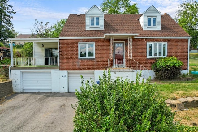 615 School St, West Mifflin, PA 15122 - cape cod house with driveway, an attached garage, brick siding, and a shingled roof