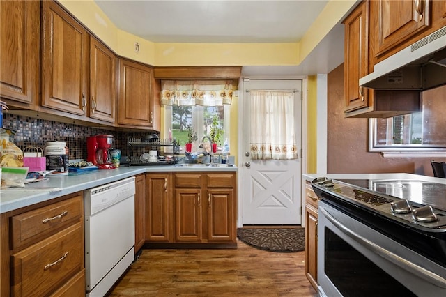 615 School St, West Mifflin, PA 15122 - kitchen featuring stainless steel electric range, white dishwasher, under cabinet range hood, brown cabinetry, and dark wood-type flooring
