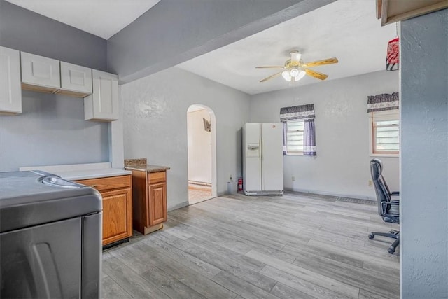 101 7th St, Monongahela City, PA 15063 - kitchen featuring white fridge with ice dispenser, ceiling fan, arched walkways, range, and light countertops