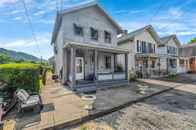 101 7th St, Monongahela City, PA 15063 - view of front facade with a porch and a mountain view