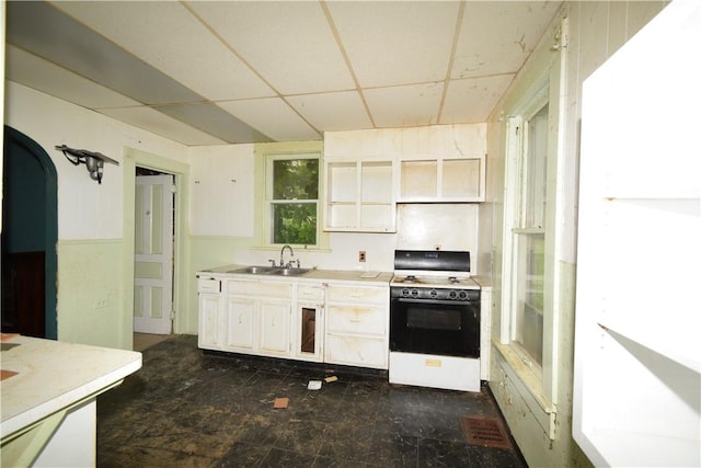 420 Tanner St, Sharon, PA 16146 - kitchen with white range oven, a paneled ceiling, light countertops, and white cabinets