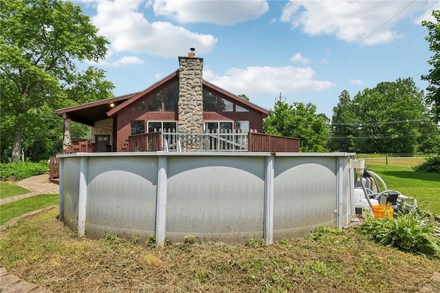 4296 Morefield Rd, Hermitage, PA 16148 - back of house featuring a chimney, a balcony, and a lawn