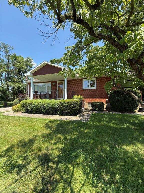 2801 7th Street Rd, Lower Burrell, PA 15068 - view of front of home featuring brick siding and a front yard