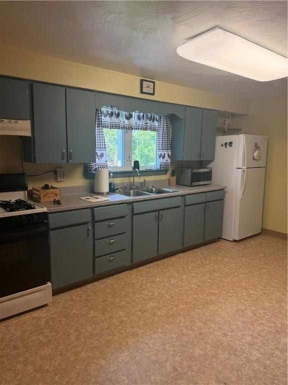 2801 7th Street Rd, Lower Burrell, PA 15068 - kitchen with gas stove, freestanding refrigerator, under cabinet range hood, stainless steel microwave, and gray cabinets