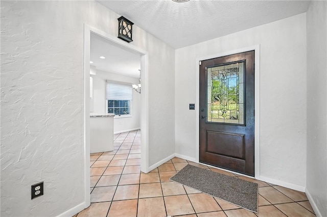 117 Clubhouse Cir, Shenango Twp Mer, PA 16159 - foyer featuring light tile patterned floors, a chandelier, and a textured ceiling