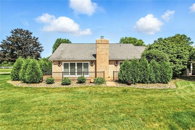 117 Clubhouse Cir, Shenango Twp Mer, PA 16159 - view of front of property with a chimney, a front yard, a wooden deck, roof with shingles, and brick siding