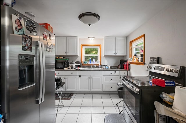 1090-94 N Darby Rd, Hermitage, PA 16148 - kitchen with appliances with stainless steel finishes, light tile patterned floors, dark countertops, and white cabinets