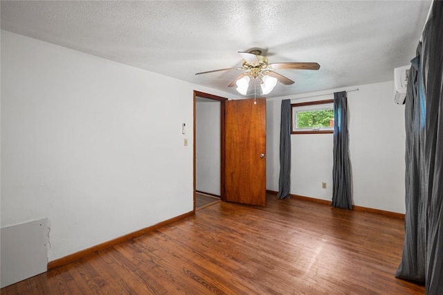 1090-94 N Darby Rd, Hermitage, PA 16148 - empty room featuring wood finished floors, a ceiling fan, a wall unit AC, and a textured ceiling