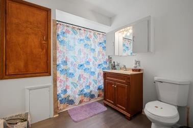 1090-94 N Darby Rd, Hermitage, PA 16148 - bathroom with vanity, a shower with shower curtain, and wood finished floors