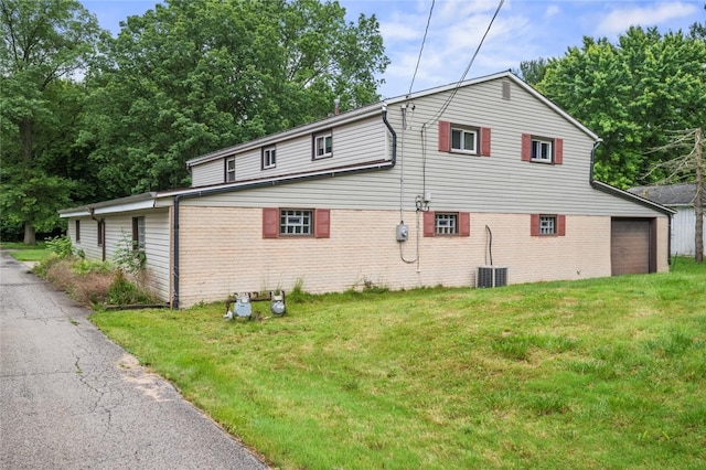 1090-94 N Darby Rd, Hermitage, PA 16148 - view of side of home featuring brick siding, a lawn, and a garage