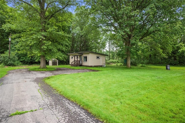 1090-94 N Darby Rd, Hermitage, PA 16148 - view of front facade with a shed, a front yard, and view of scattered trees