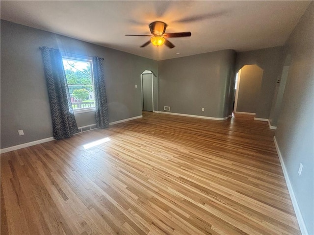 26 Mount View Dr, Burgettstown Boro, PA 15021 - empty room with arched walkways, a ceiling fan, and light wood-type flooring