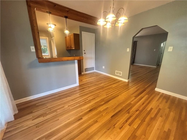 26 Mount View Dr, Burgettstown Boro, PA 15021 - unfurnished dining area featuring a chandelier, light wood finished floors, beam ceiling, and arched walkways