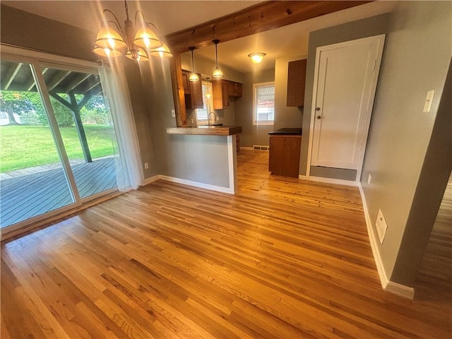 26 Mount View Dr, Burgettstown Boro, PA 15021 - unfurnished living room with wood finished floors, a chandelier, and beamed ceiling