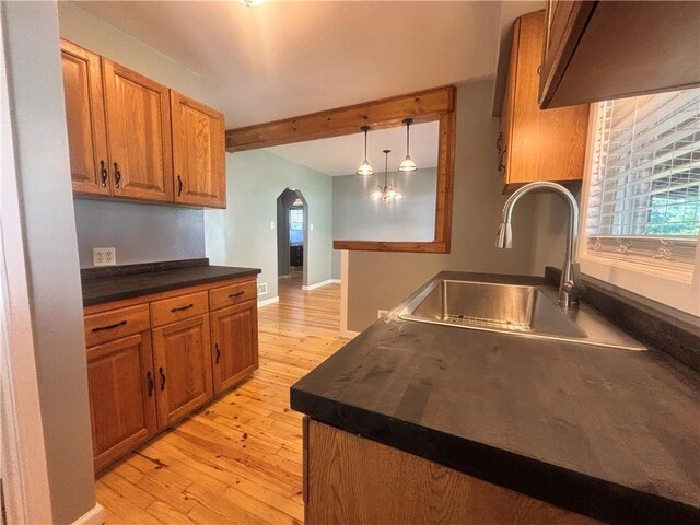 26 Mount View Dr, Burgettstown Boro, PA 15021 - kitchen featuring dark countertops, arched walkways, brown cabinets, and beamed ceiling