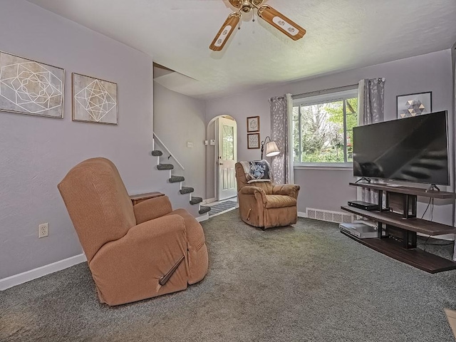 1138 Union Ave, Brackenridge, PA 15014 - living room with arched walkways, stairs, carpet, and a ceiling fan