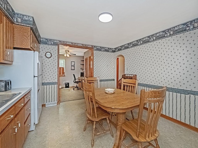 1138 Union Ave, Brackenridge, PA 15014 - dining area with wallpapered walls, a ceiling fan, and light flooring