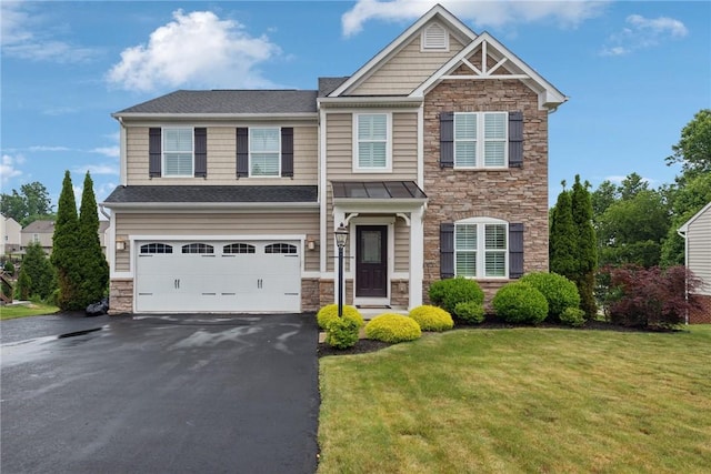 509 Saddle Ridge Dr, Penn Twp Wml, PA 15642 - craftsman house featuring stone siding, a garage, driveway, and a front yard