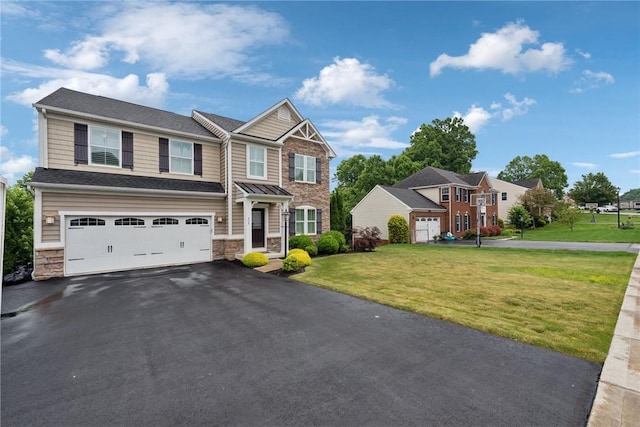 509 Saddle Ridge Dr, Penn Twp Wml, PA 15642 - view of front facade featuring stone siding, driveway, an attached garage, and a front yard