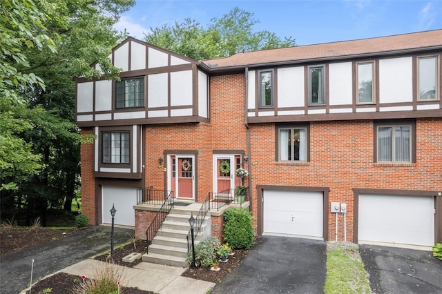 206 Little Hollow Dr, Aleppo, PA 15143 - view of front facade with a garage, asphalt driveway, brick siding, and stucco siding