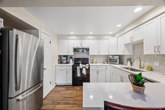206 Little Hollow Dr, Aleppo, PA 15143 - kitchen featuring stainless steel appliances, dark wood-style flooring, white cabinets, a peninsula, and decorative backsplash