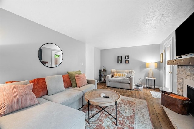 206 Little Hollow Dr, Aleppo, PA 15143 - living room featuring wood-type flooring, a fireplace, and a textured ceiling