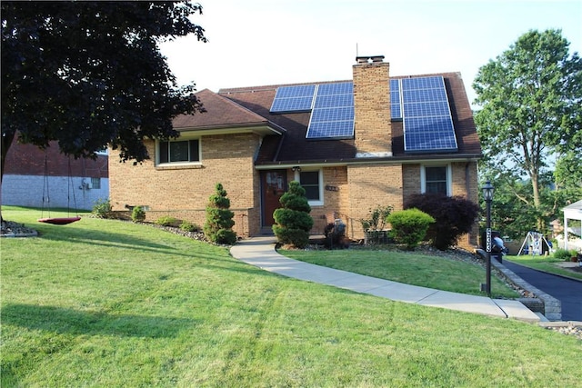 533 Charlotte Dr, Baldwin Boro, PA 15236 - view of front of home featuring brick siding, solar panels, a front yard, and a chimney