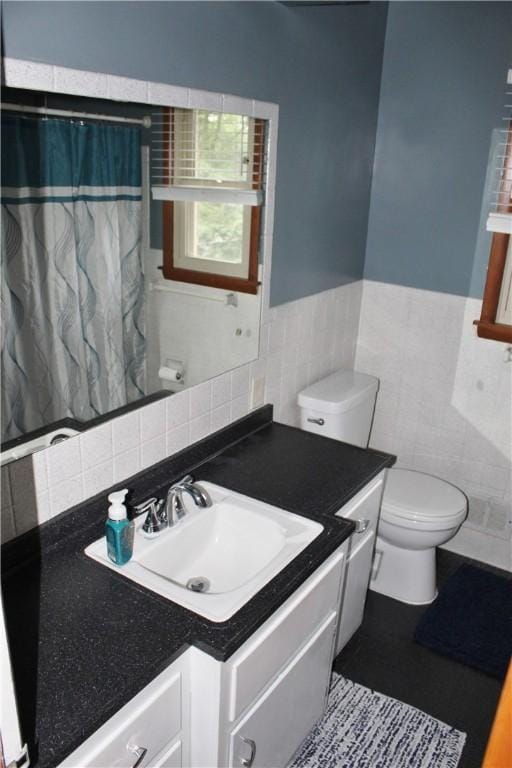 533 Charlotte Dr, Baldwin Boro, PA 15236 - bathroom with tile walls, vanity, wainscoting, and a shower with shower curtain