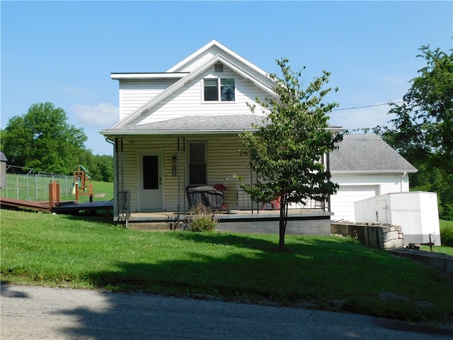 577 Woodside Old Frame Rd, Smithfield, PA 15478 - view of front of home featuring covered porch, a front lawn, a playground, and roof with shingles