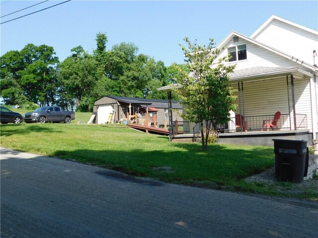 577 Woodside Old Frame Rd, Smithfield, PA 15478 - view of front of house featuring a front lawn, a storage unit, and a porch