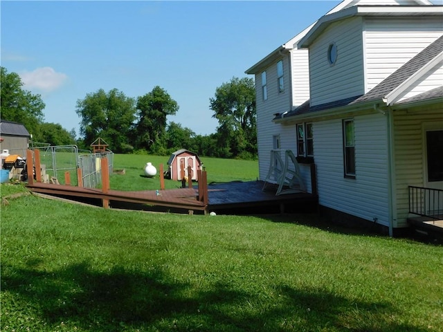 577 Woodside Old Frame Rd, Smithfield, PA 15478 - view of green lawn featuring a wooden deck and a storage unit