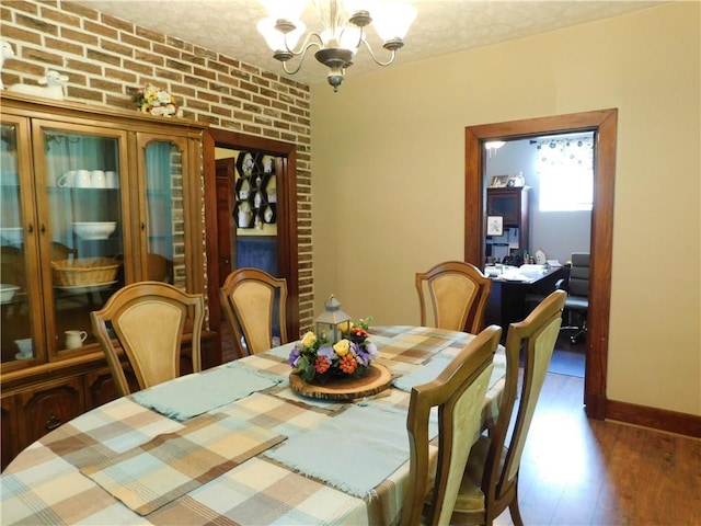 577 Woodside Old Frame Rd, Smithfield, PA 15478 - dining space featuring a chandelier, wood finished floors, and brick wall
