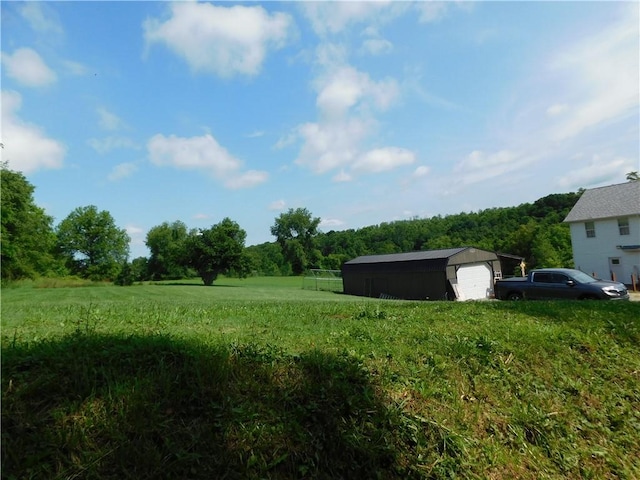 577 Woodside Old Frame Rd, Smithfield, PA 15478 - view of yard featuring an outbuilding, a detached garage, and a view of trees