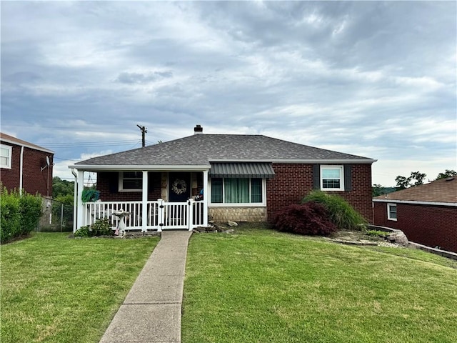 217 Livingston Rd, West Mifflin, PA 15122 - view of front facade featuring a porch, a front lawn, a shingled roof, and brick siding