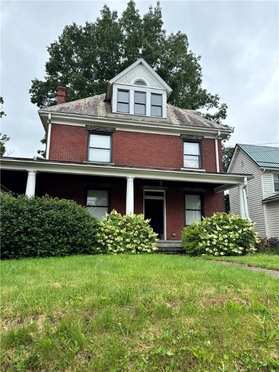 409 Beaver St, Mars Boro, PA 16046 - traditional style home with brick siding, a porch, a front lawn, and a chimney