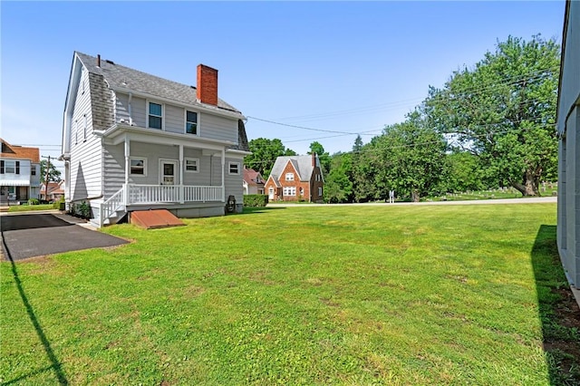616 W College St, Canonsburg, PA 15317 - rear view of house with a chimney, a yard, and a shingled roof