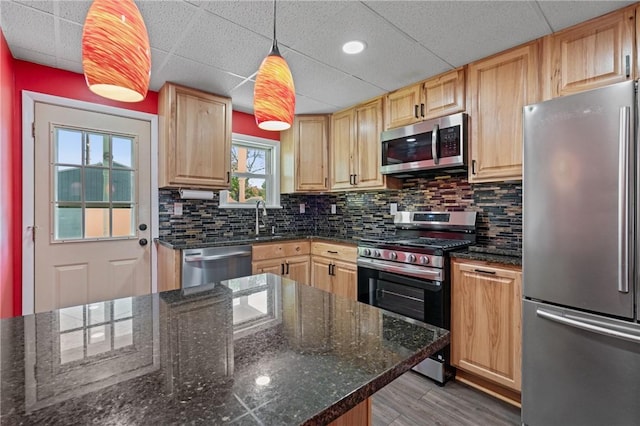 616 W College St, Canonsburg, PA 15317 - kitchen with stainless steel appliances, a paneled ceiling, light brown cabinetry, tasteful backsplash, and hanging light fixtures