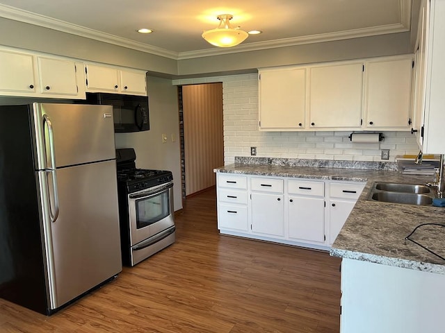 170 Canal St, Center Twp/Homer Cty, PA 15748 - kitchen with appliances with stainless steel finishes, ornamental molding, white cabinetry, dark wood finished floors, and backsplash